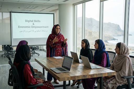 Women participating in a Digital Skills and Economic Empowerment training session overlooking the Makran coastline